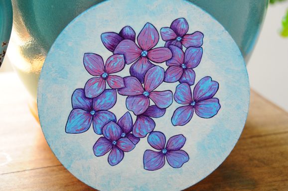 small hydrangea flower painting in gouache on round canvas board