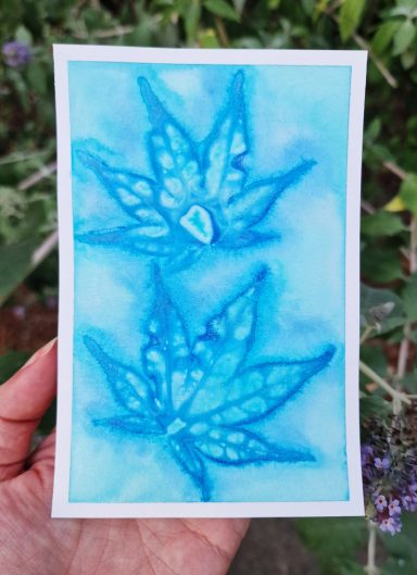 semi abstract print in watercolour with an imprint or Japanese maple leaves in blue.